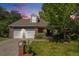 Charming two-story home featuring a well-manicured lawn, brick accents, and a two-car garage at 10247 W Roxbury Pl, Littleton, CO 80127