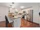 Spacious kitchen featuring granite countertops, stainless steel appliances, and modern pendant lighting at 10247 W Roxbury Pl, Littleton, CO 80127