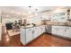 Spacious kitchen featuring granite countertops, stainless steel appliances, and modern pendant lighting at 10247 W Roxbury Pl, Littleton, CO 80127