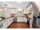 Spacious kitchen featuring granite countertops, stainless steel appliances, and modern pendant lighting at 10247 W Roxbury Pl, Littleton, CO 80127