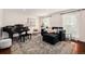 Cozy living room featuring a piano, comfortable seating, and natural light, creating a welcoming and inviting space at 10247 W Roxbury Pl, Littleton, CO 80127