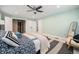 Spacious main bedroom with large windows, a stylish ceiling fan, and a walk-in closet, offering ample storage space at 10247 W Roxbury Pl, Littleton, CO 80127