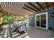 Inviting covered patio with a dining set, perfect for outdoor entertaining and relaxation at 10247 W Roxbury Pl, Littleton, CO 80127