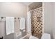 Bathroom featuring a tiled shower, towel racks, and modern fixtures, providing a comfortable and functional space at 10247 W Roxbury Pl, Littleton, CO 80127