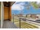 Wood-look deck flooring and horizontal metal railings make this balcony a comfortable perch to view the neighborhood at 3000 S Elati St, Englewood, CO 80110