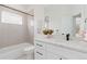 Bright bathroom with modern fixtures, marble countertop, and stylish tiling at 3000 S Elati St, Englewood, CO 80110