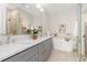 Bathroom boasts dual sinks, a soaking tub, and a luxurious glass-enclosed shower at 3000 S Elati St, Englewood, CO 80110