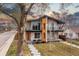 Modern two-story home with a striking design, landscaped front yard, and second-story balconies at 3000 S Elati St, Englewood, CO 80110