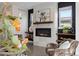 Modern fireplace with tile surround, wood mantle and shelves, in a cozy living room with natural light at 3000 S Elati St, Englewood, CO 80110