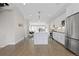 Bright open kitchen with white cabinets, marble island, and stainless steel appliances at 3000 S Elati St, Englewood, CO 80110