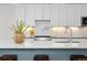 Close-up of kitchen with stainless steel cooktop, marble counters, and stylish decor at 3000 S Elati St, Englewood, CO 80110