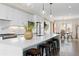 Bright, modern kitchen featuring a large island with seating and pendant lighting, stainless appliances, and dining area at 3000 S Elati St, Englewood, CO 80110