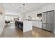 Spacious kitchen with a large marble island, stainless steel appliances and white cabinetry at 3000 S Elati St, Englewood, CO 80110