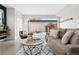 Cozy living room with large sliding glass doors opening to an outdoor deck with chairs and lighting at 3000 S Elati St, Englewood, CO 80110