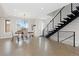 Bright, open-concept living room with hardwood floors, modern staircase, and natural light at 3000 S Elati St, Englewood, CO 80110