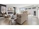 Comfortable living room featuring a fireplace, ample seating, and access to the deck at 3000 S Elati St, Englewood, CO 80110