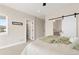 Bright, carpeted main bedroom features a barn door leading to the ensuite bathroom and walk-in closet at 3000 S Elati St, Englewood, CO 80110