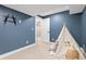 Playroom featuring blue accent wall and play tent providing an imaginative area at 3000 S Elati St, Englewood, CO 80110