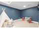 Fun playroom featuring blue accent wall and cute tent. Great space for  at 3000 S Elati St, Englewood, CO 80110