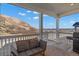 Covered balcony with outdoor seating, a grill, and stunning views of the mountains and surrounding landscape at 1044 Oleander St, Castle Rock, CO 80109