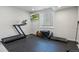 Finished basement provides space for a home gym with rubber flooring, television, and window with light-filtering shades at 1044 Oleander St, Castle Rock, CO 80109