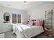Cozy bedroom with a bed, ample natural light from the window, and stylish shelving at 1044 Oleander St, Castle Rock, CO 80109