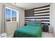 Bedroom with a large window view, American flag tapestry, and dark wood furniture at 1044 Oleander St, Castle Rock, CO 80109