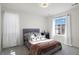 Bright bedroom featuring a tufted headboard, plush bedding, and ample natural light at 1044 Oleander St, Castle Rock, CO 80109