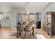 Bright dining area with wooden table, stylish chairs, and sliding doors leading to a balcony with mountain views at 1044 Oleander St, Castle Rock, CO 80109