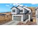 Charming two-story home featuring a gray garage door, modern farmhouse style, and professionally landscaped front yard at 1044 Oleander St, Castle Rock, CO 80109
