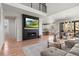 Bright, open-concept living room with a modern fireplace, wood floors, and access to the dining area and kitchen at 1044 Oleander St, Castle Rock, CO 80109