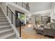 Spacious living room features a fireplace, an adjacent staircase, and natural light from large windows at 1044 Oleander St, Castle Rock, CO 80109