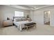 Serene primary bedroom with neutral tones, tray ceiling, a comfortable bed, and an ensuite bathroom at 1044 Oleander St, Castle Rock, CO 80109
