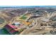Aerial view of a sports complex with a soccer field, covered seating, parking lot, and winding walking path at 1044 Oleander St, Castle Rock, CO 80109