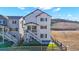 A charming two-story home featuring an inviting deck, a well-maintained yard, and scenic views of surrounding landscape at 1044 Oleander St, Castle Rock, CO 80109