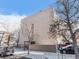 View of building exterior on a winter day with surrounding snow and parked vehicles at 1390 N Emerson St # 105, Denver, CO 80218