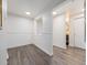 Bright hallway featuring hardwood floors and white trim with access to the bathroom at 1390 N Emerson St # 105, Denver, CO 80218