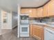 Compact kitchen features matching white appliances and light wooden cabinets at 1390 N Emerson St # 105, Denver, CO 80218