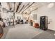 Large basement area with carpet and a variety of equipment, providing ample storage and potential uses at 10689 Shadow Pines Rd, Parker, CO 80138