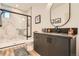 Modern bathroom features a glass-enclosed shower with marble tile and a stylish vanity with a black countertop at 10689 Shadow Pines Rd, Parker, CO 80138