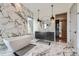 Elegant bathroom featuring marble walls, a freestanding tub, and modern fixtures at 10689 Shadow Pines Rd, Parker, CO 80138