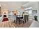 Bright dining area with a modern chandelier, large windows, and seating for eight at 10689 Shadow Pines Rd, Parker, CO 80138