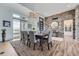 Elegant dining area with stone accent wall, modern chandelier, and abundant natural light at 10689 Shadow Pines Rd, Parker, CO 80138