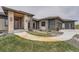 Charming home entrance with stone accents, walkway, and manicured landscaping at 10689 Shadow Pines Rd, Parker, CO 80138