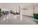 Spacious three car garage with pristine floor and ample space for storage or projects at 10689 Shadow Pines Rd, Parker, CO 80138