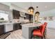 Modern kitchen with an island, stainless steel appliances, and warm pendant lighting at 10689 Shadow Pines Rd, Parker, CO 80138