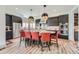 Modern kitchen with island seating, stainless steel appliances, and pendant lighting at 10689 Shadow Pines Rd, Parker, CO 80138