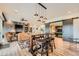 Inviting living room area with fireplace, dining table, and view to basement rec room at 10689 Shadow Pines Rd, Parker, CO 80138