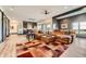 Open-concept living room with a large sectional sofa and view to connected kitchen at 10689 Shadow Pines Rd, Parker, CO 80138