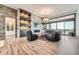 Inviting living room with a stone fireplace, custom shelves, and a wall of sliding glass doors at 10689 Shadow Pines Rd, Parker, CO 80138